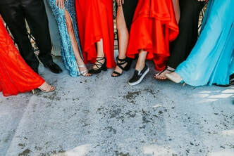 Students showing their outfit and shoes for prom.