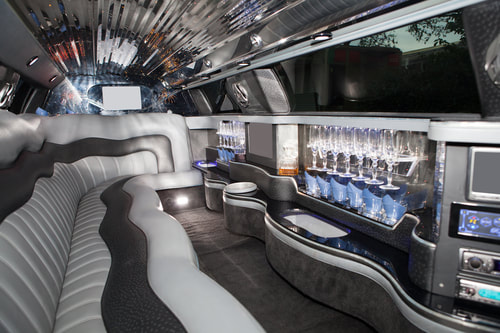 A picture of a limo interior with gray seats.