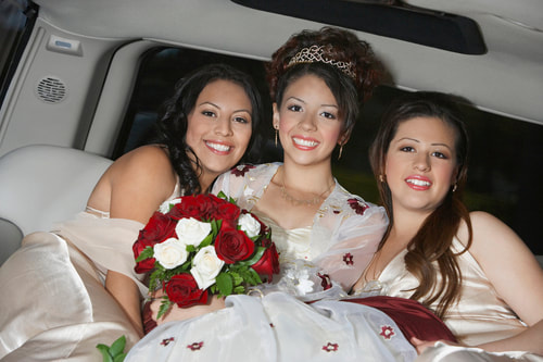 A quinceanera birthday girl in a limo with friends.